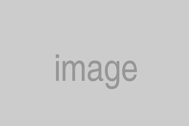 car-tire-service-worker-sitting-on-car-tyres-PXMHDZ3